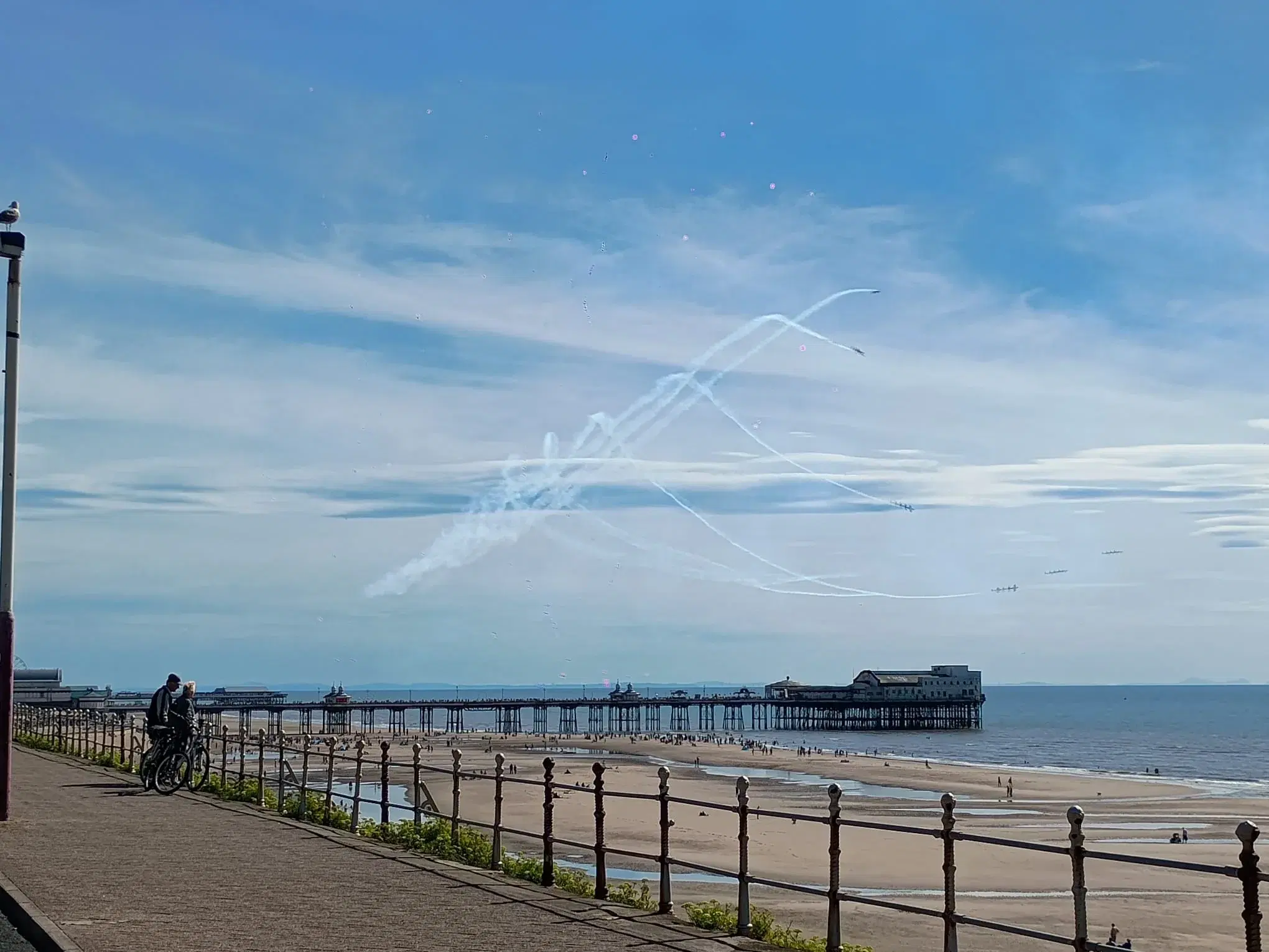 Aircraft drawing trails in the sky above North Pier