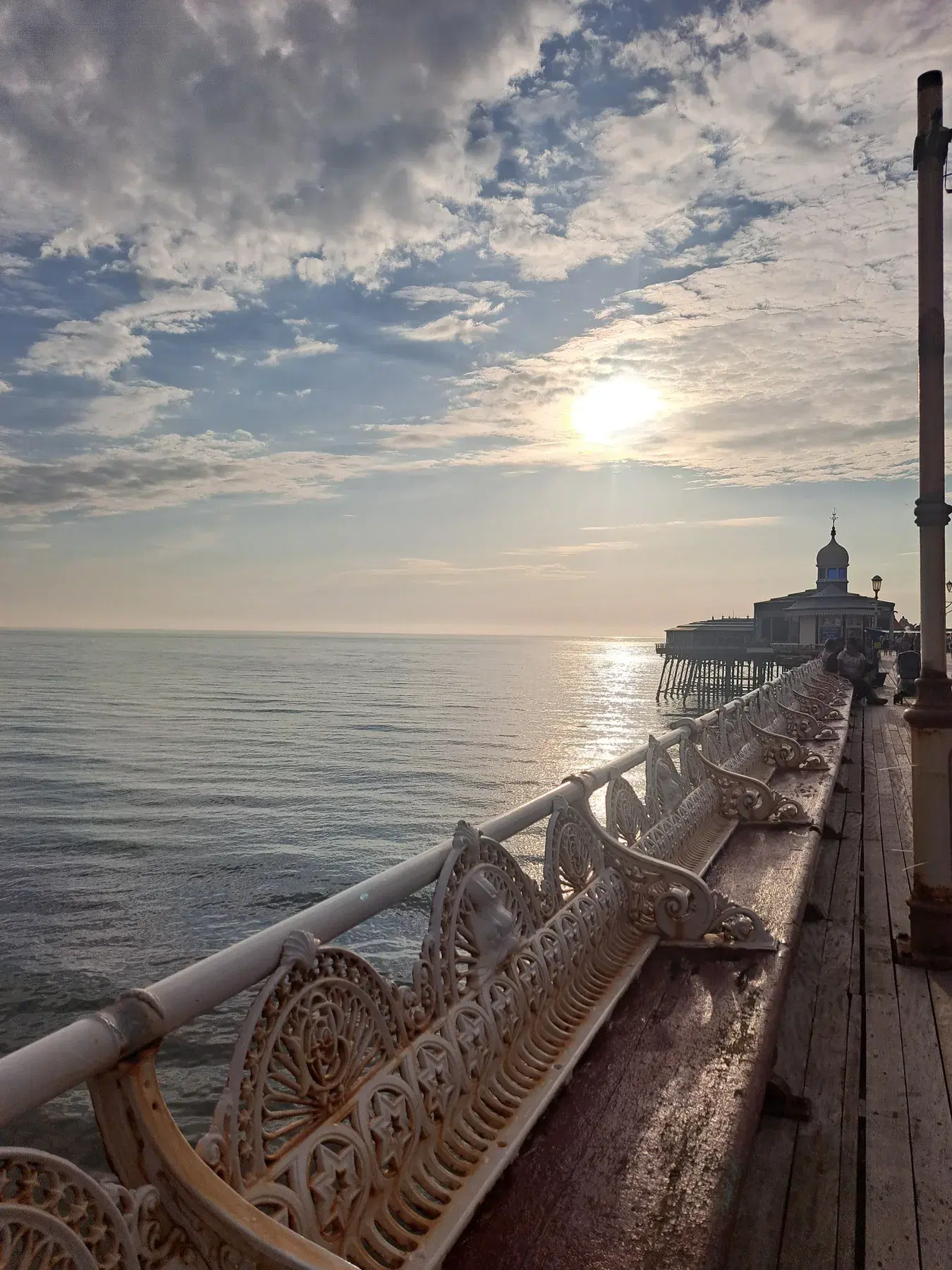 North Pier's ornate benches leading towards the pier head in evening light