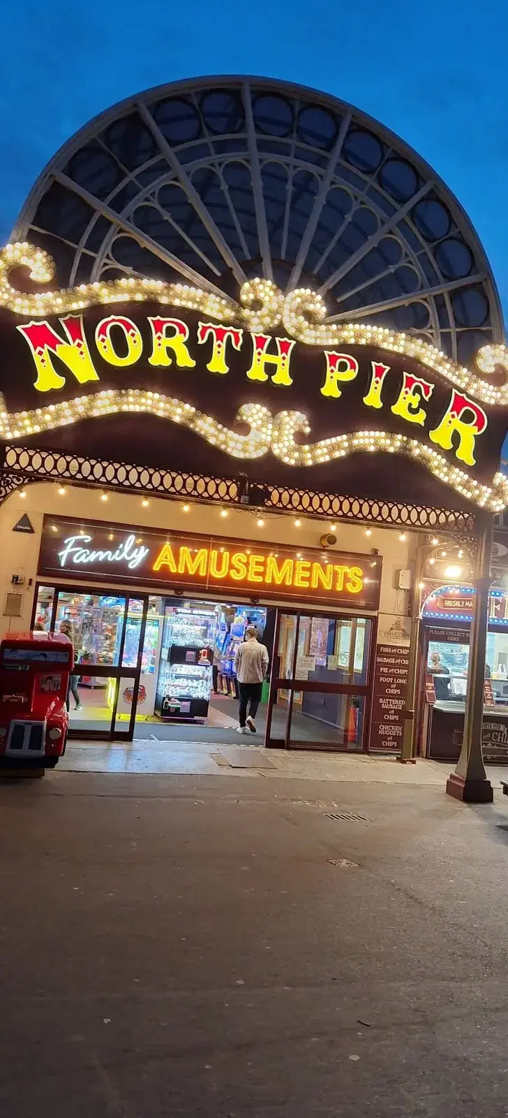 The illuminated North Pier family amusements entrance at night