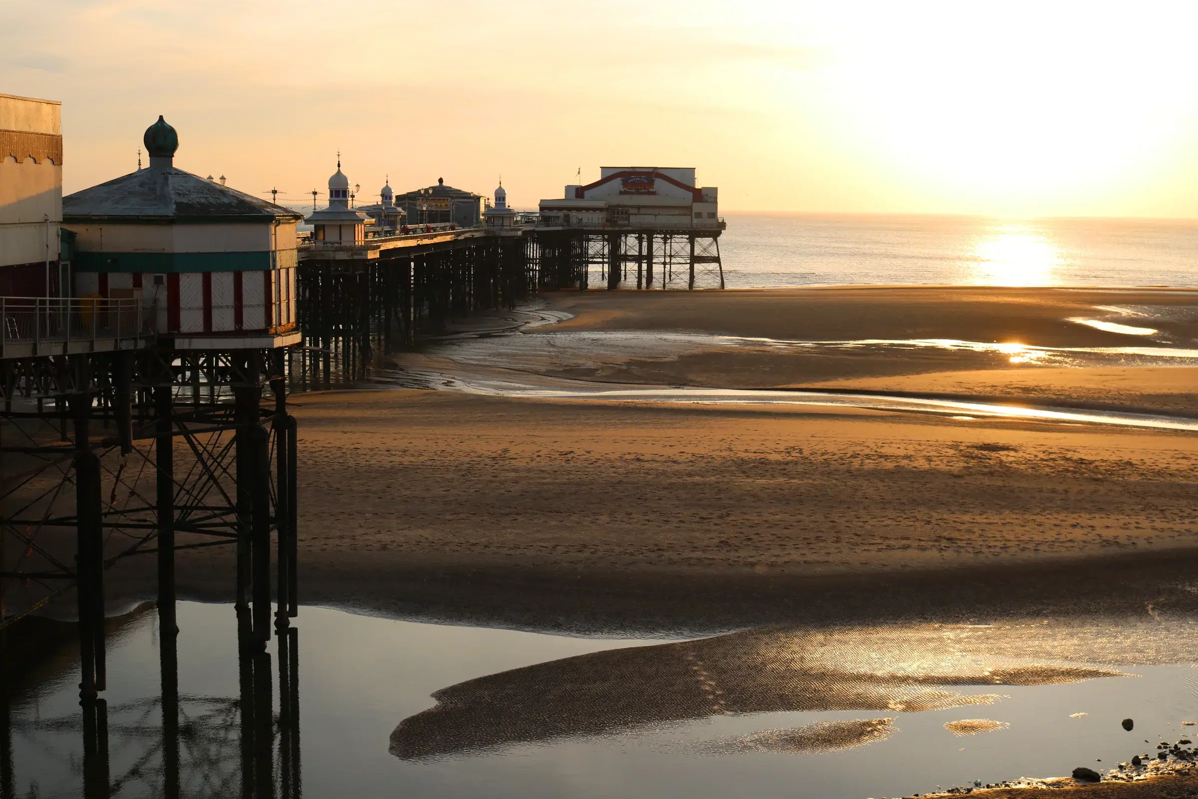 North Pier reaching across the beach towards a golden sunset