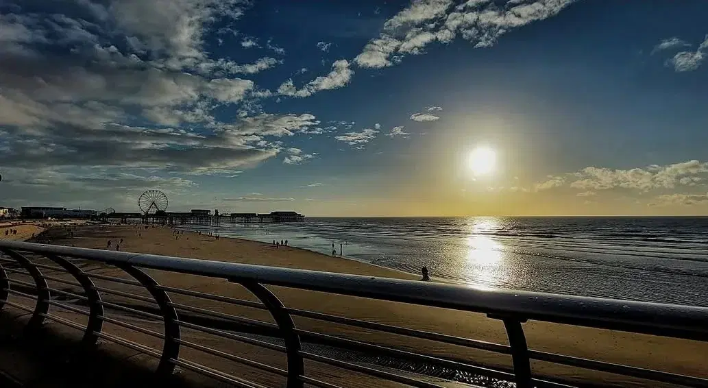The evening sun over the sea and Blackpool promenade, viewed from North Pier