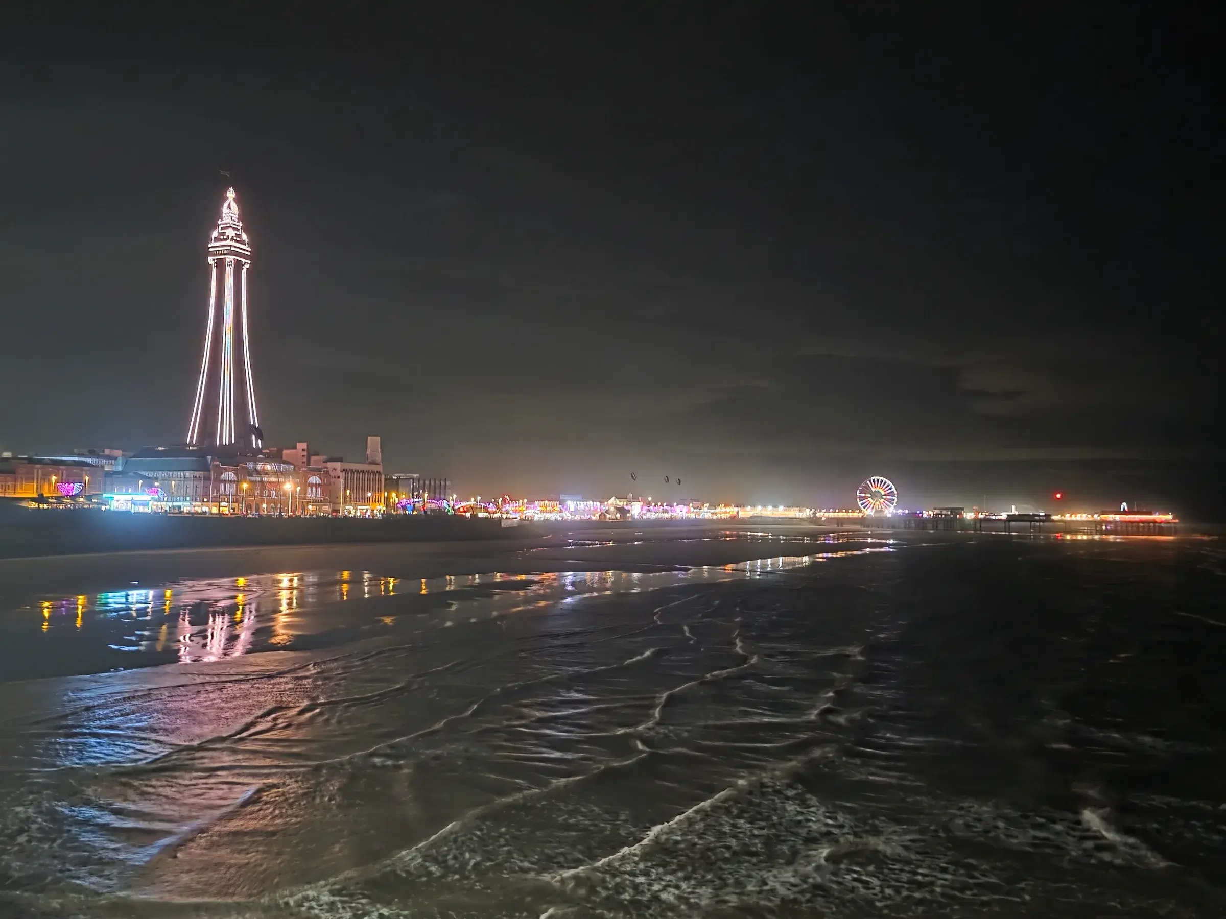 Blackpool Tower illuminated beyond the sea at night